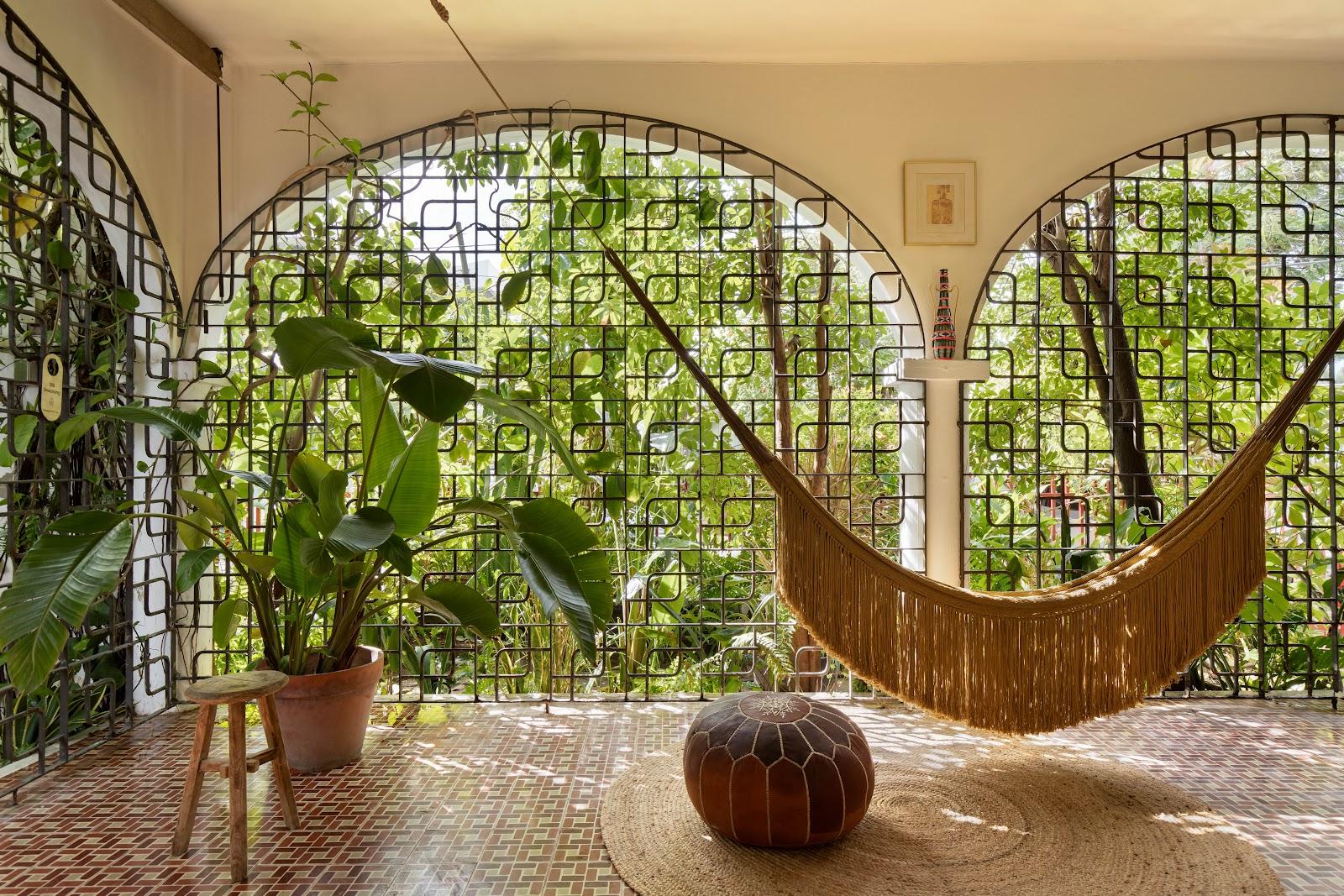 A hammock slung in a planted outdoor corner at Dreamcatcher, the flagship boutique hotel of Dreamers Welcome, in Ocean Park.