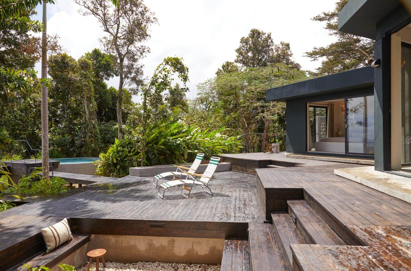 The deck, fire pit and saltwater pool at Selva by DW, the Dreamers Welcome rainforest house near Luquillo.