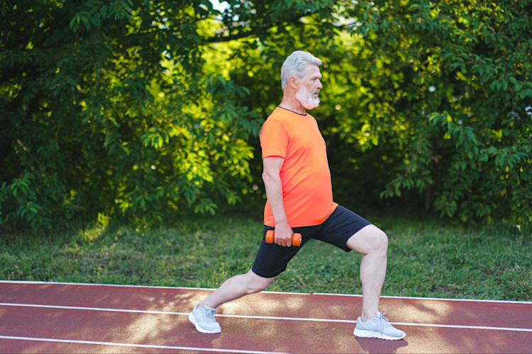 An older man exercises through his SilverSneakers program.
