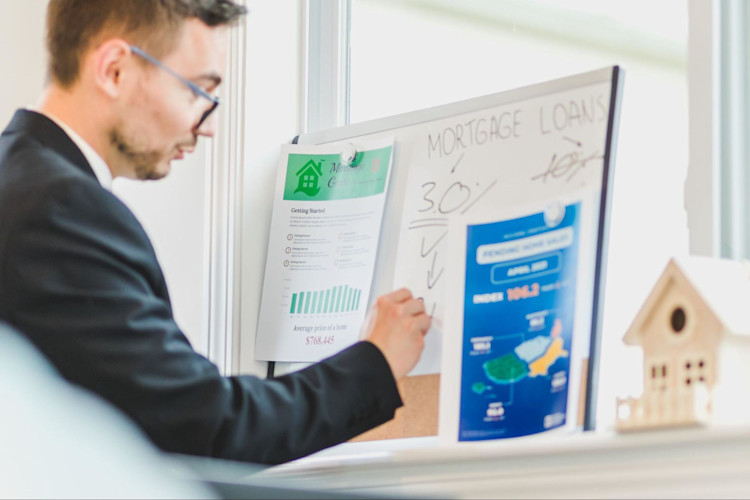 A man comparing the advantages and disadvantages of Mortgage Life Insurance.