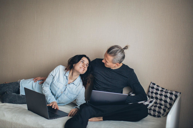 A couple who are smiling because they have Whole Life Insurance.
