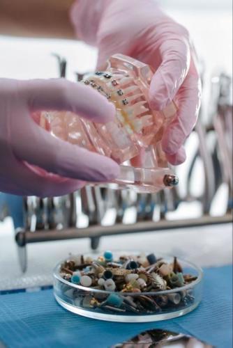 An orthodontist working with braces.