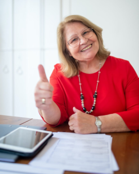 A woman happy with her Insurance plan.