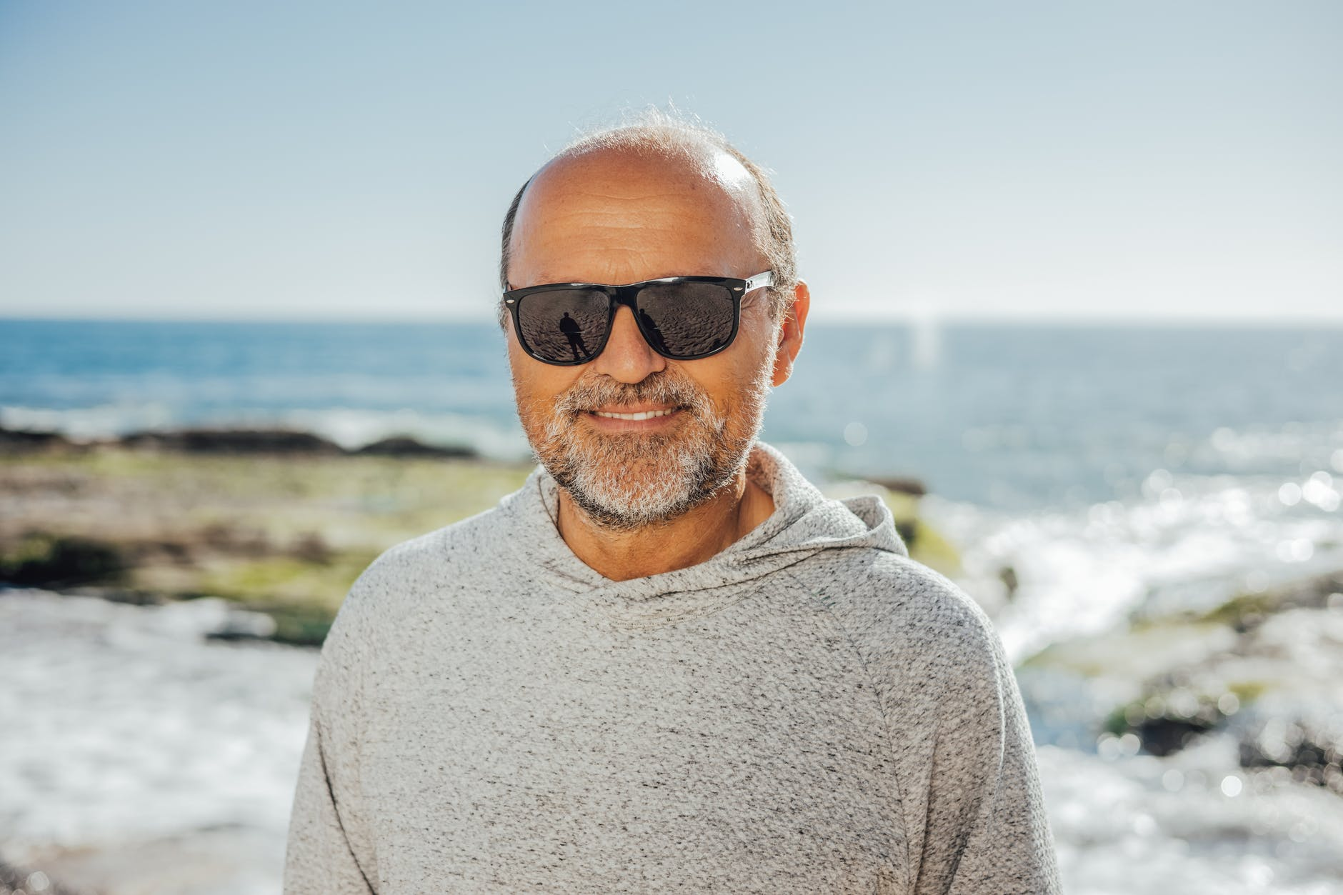 An older man smiling while on holiday.