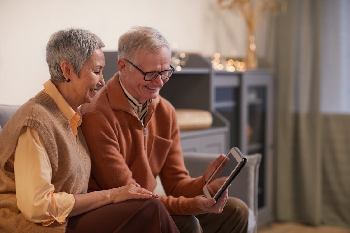 An elderly couple that is reviewing their Medicare Plan F.