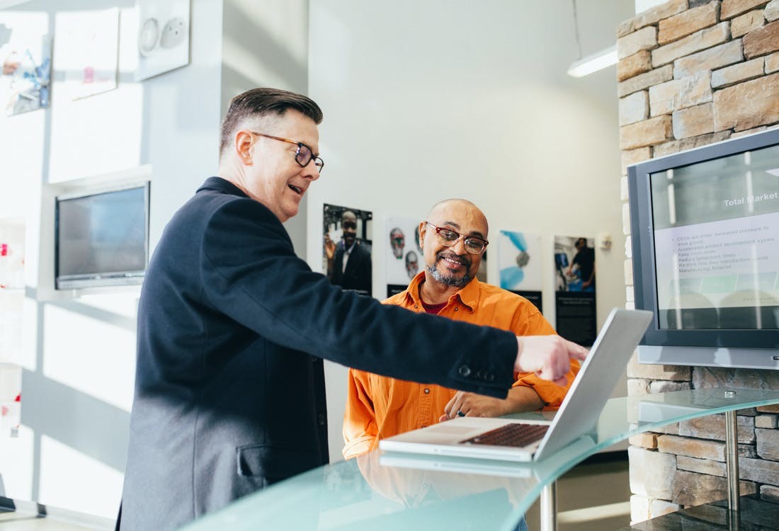 Medicare insurance agent showing his client the different Medicare Plans.