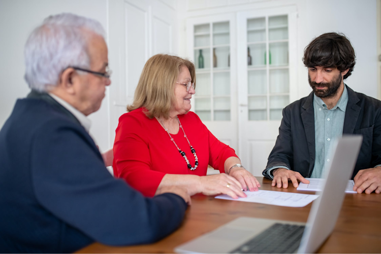 An elderly couple signing up for Term Life Insurance.