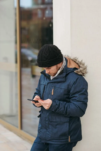 Man looking at phone checking identity theft protection app