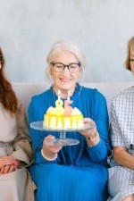 Woman celebrating her birthday and is now eligible for certain Medicare options.