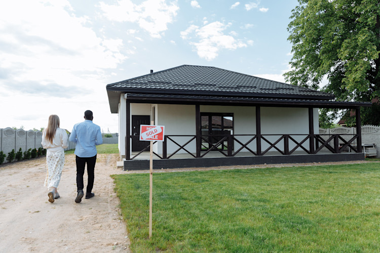 Couple Walking towards Their New House after completing interior and exterior inspections
