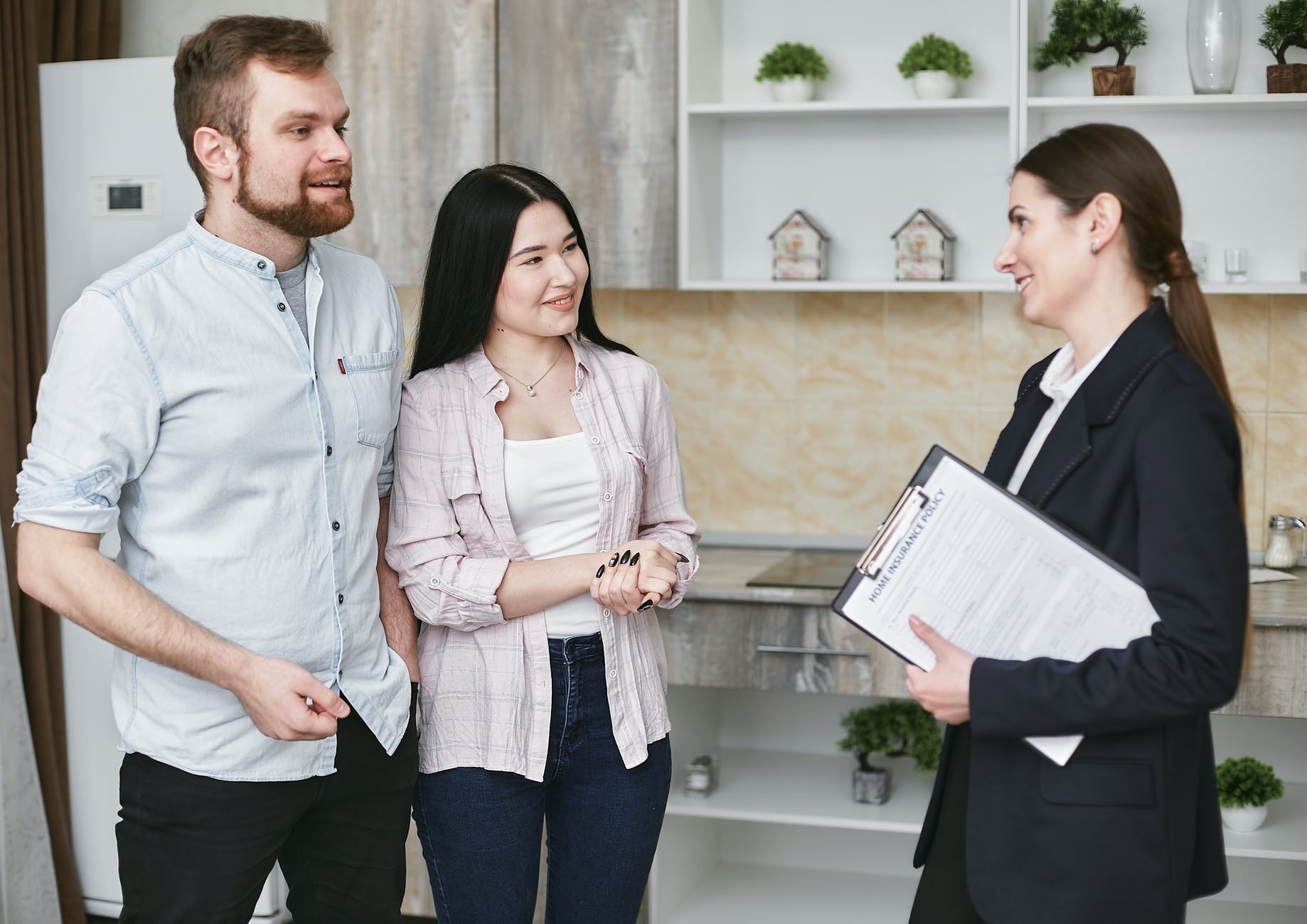 An insurance agent talking to her clients about Term Life Insurance.