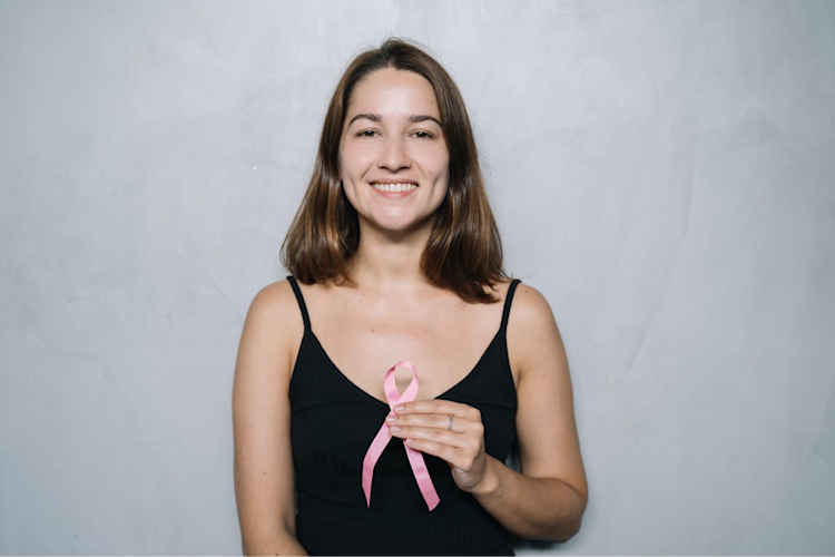 A woman with cancer who is smiling because she can still get life insurance.