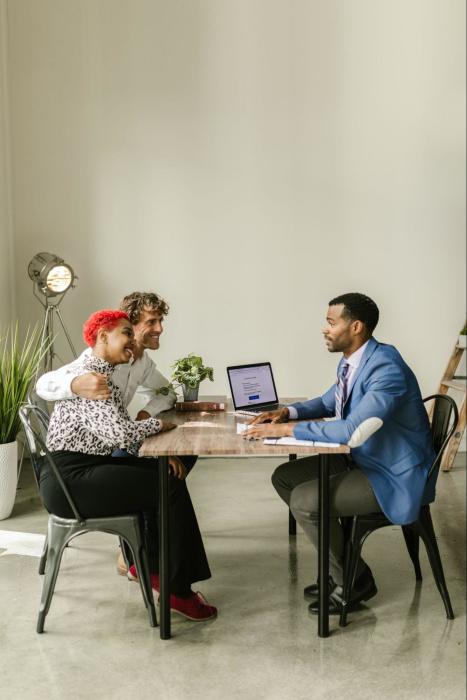A couple that is signing up for Term Life Insurance with their insurance agent.