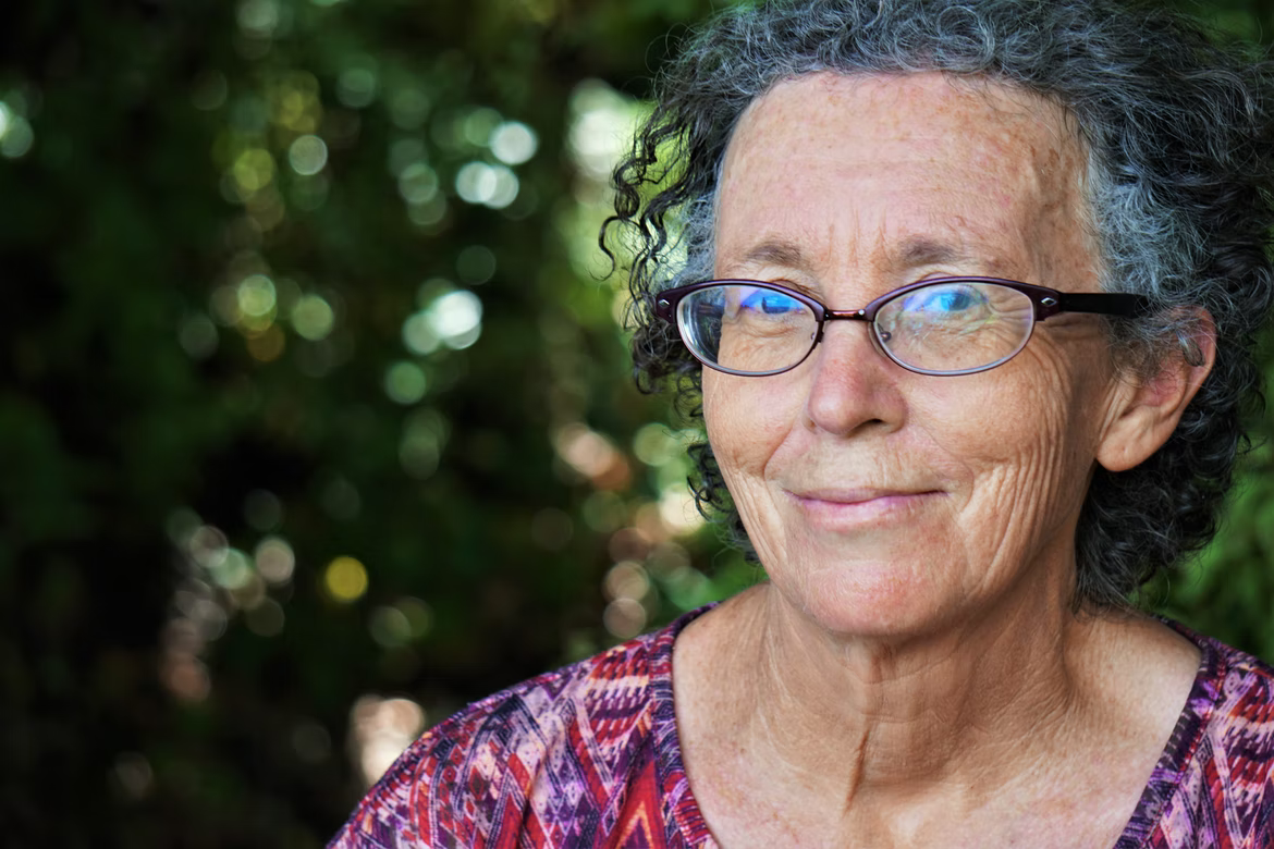 A woman who is happy because her chemotherapy is covered by Medicare.