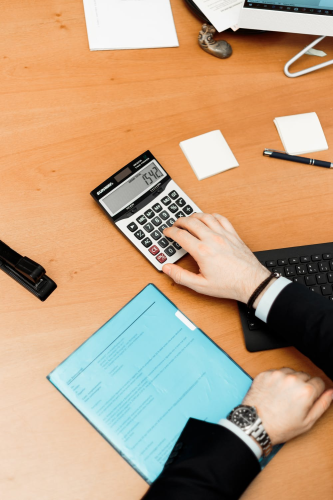 A person calculating their life insurance costs.