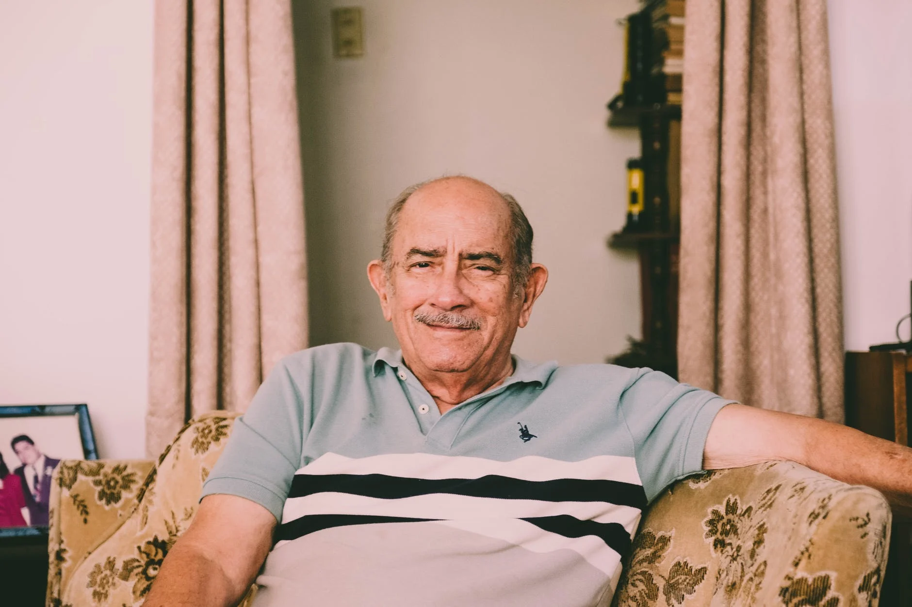 A older man smiling because he has complete coverage for his medical costs.