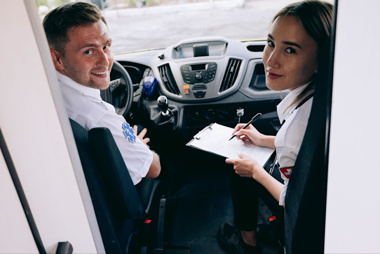 Healthcare Professionals in an Ambulance taking a patient to their medical appointment