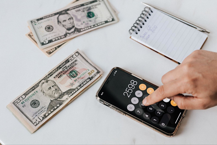 A person calculating how much they have in their Medical Savings Account.
