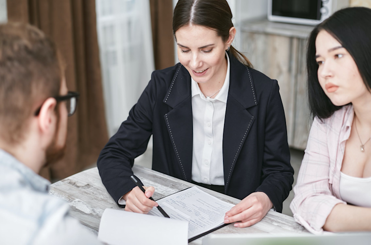 An insurance agent explaining to her customers how Group Life Insurance works.