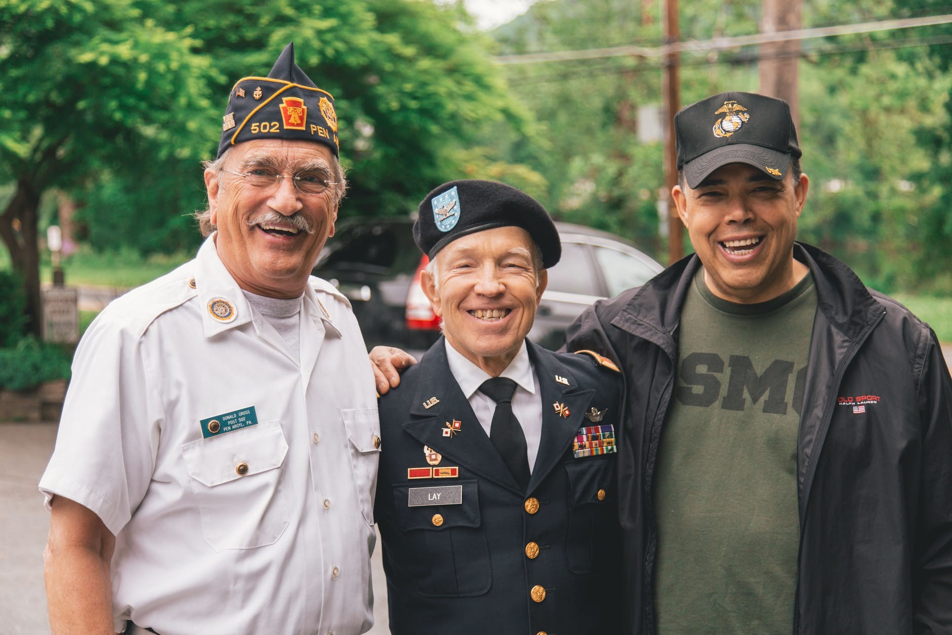 A group of veterans smiling because TRICARE and Medicare work together.