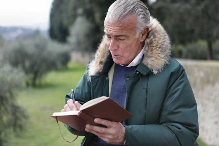 A man who is reviewing the differences between variable Universal Life Insurance vs Variable Life Insurance.