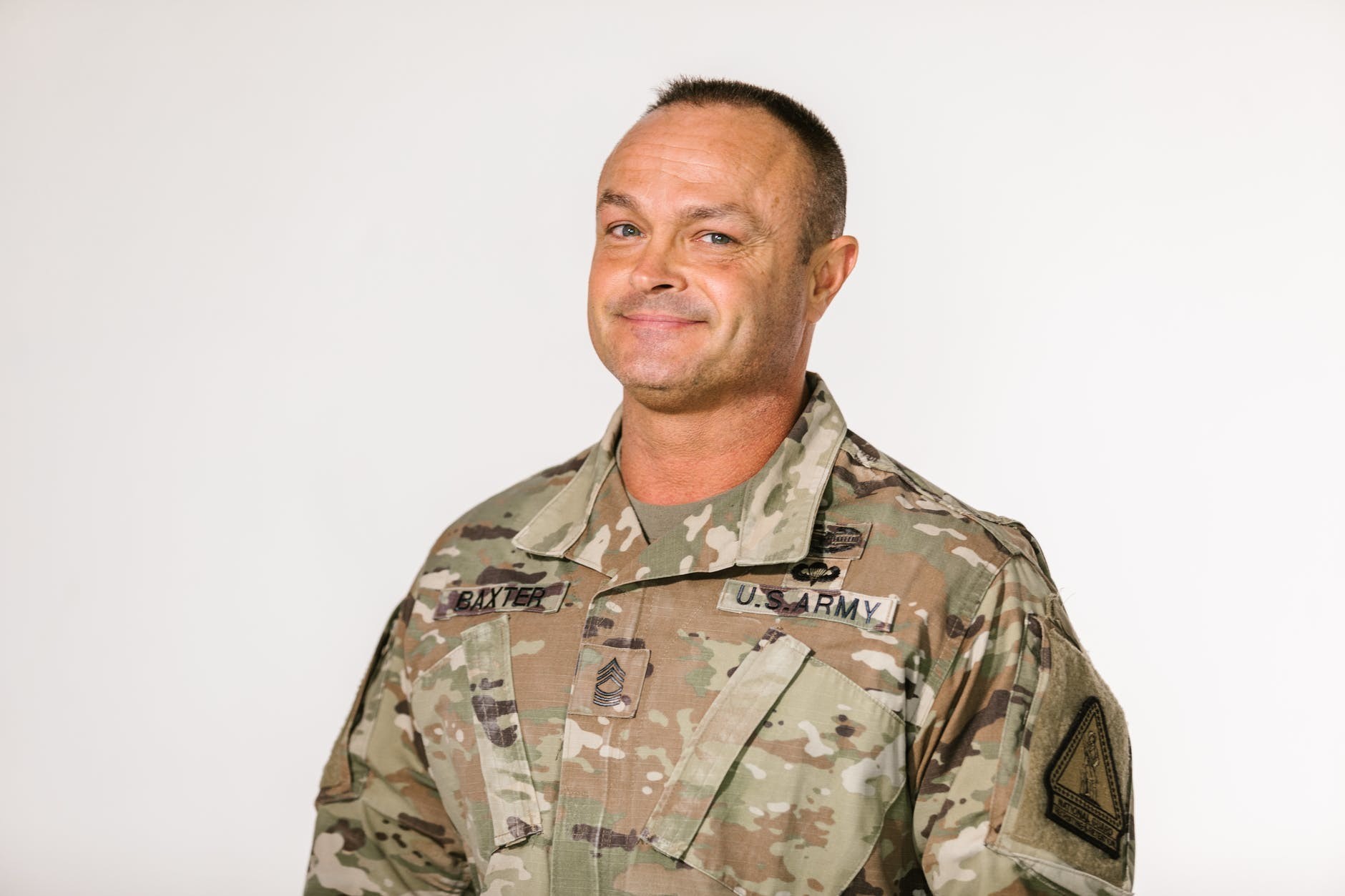 A smiling older member of the U.S. armed forces who has just joined Medicare.
