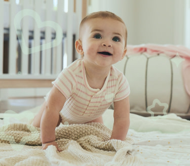 Baby smiles while crawling on the floor