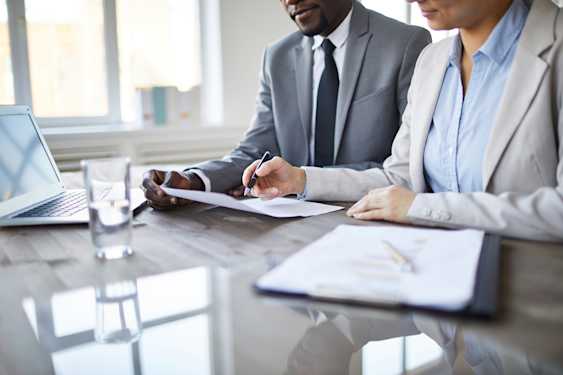Persons reviewing documents as part of the due diligence process.
