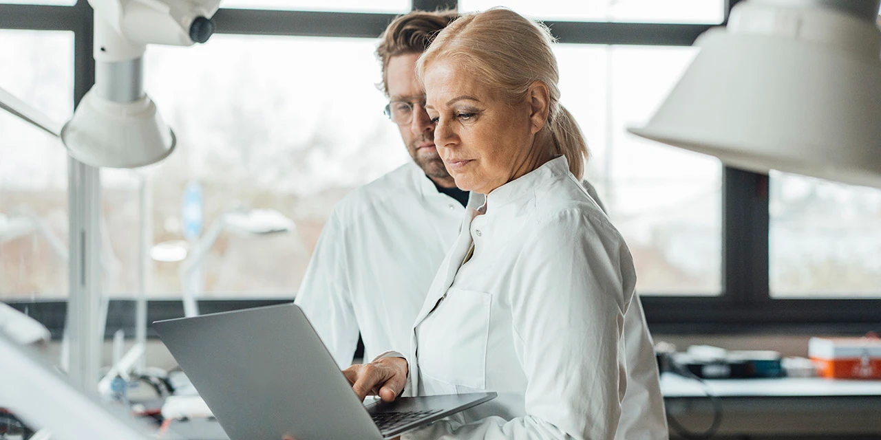 Photo portraying two scientists at a laptop (Photo credit: Westend61 via Getty Images)