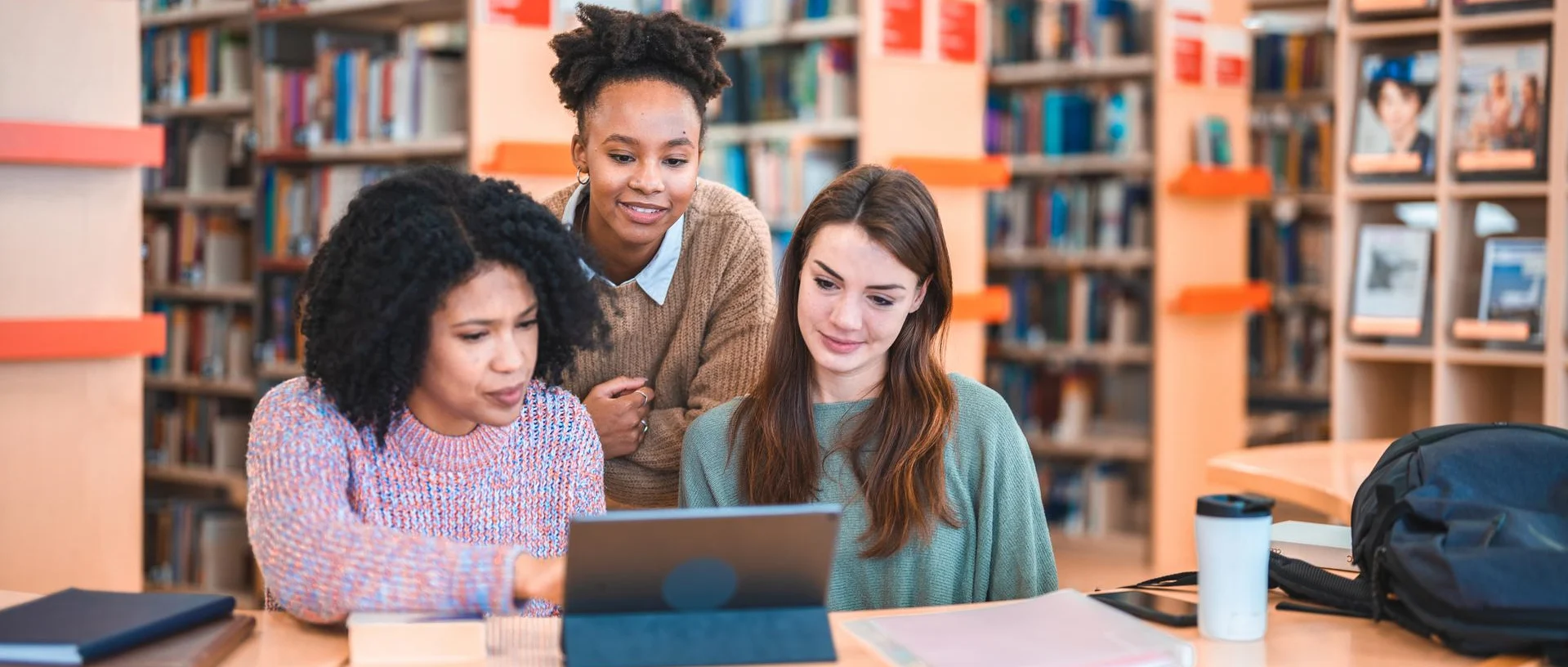 Diverse Females Studying In A Library
