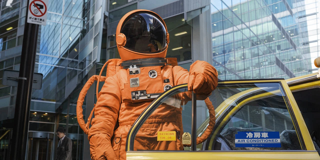 Image from cover of Elsevier's Back to Earth report (November 2023): an astronaut in an orange space suit with a yellow taxi