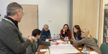 Professionals collaborating across table in an office setting