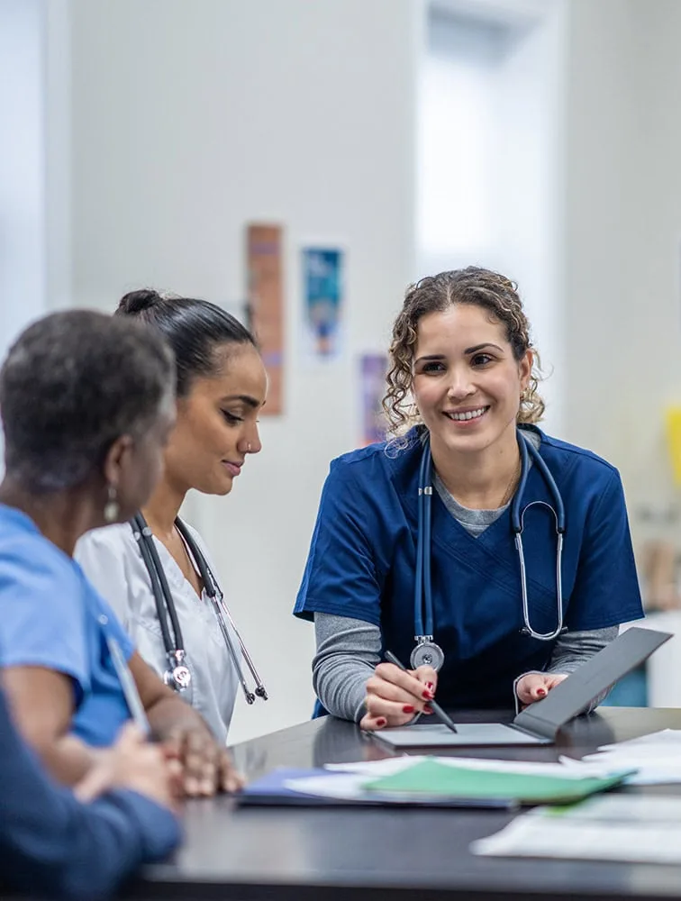 Nurses having a conversation at a table