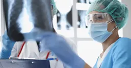 Nurse inspecting X-ray photograph