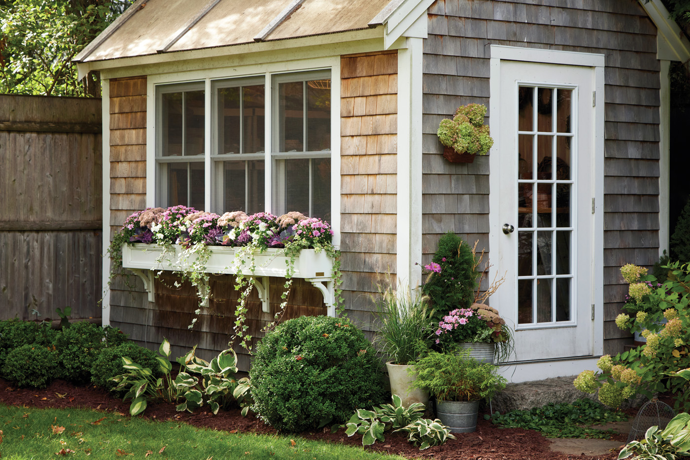 GG188 SW 05 82A9770: Perennials are great in containers too! The tall sedum in the windowbox and the container next to the door will join their border companions nearby at the end of the season.