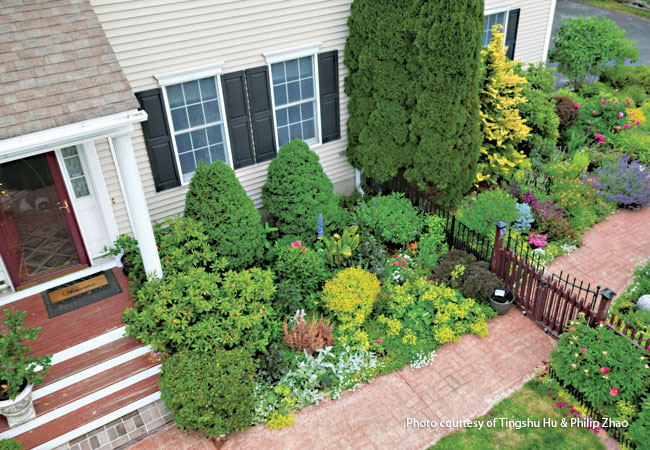174-FG-reader-garden-winners-front-entry-2: A mix of dwarf conifers, deciduous shrubs, perennials and annuals keep this entry garden colorful throughout the year.