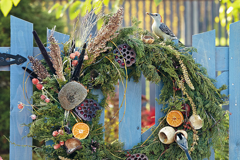 design-roundup-bird-feeding-wreath-550x822: A a wide variety of birds will find something to snack on with this bird focused wreath. 