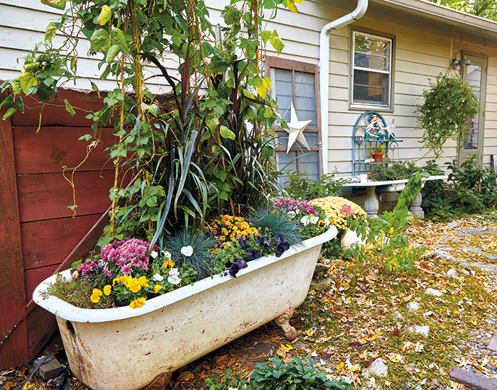 budget-friendly-garden-bathtub-planter: Pull the plug on the drain and leave holes for fixtures open for drainage, but cover them with fine mesh to prevent clogging. 