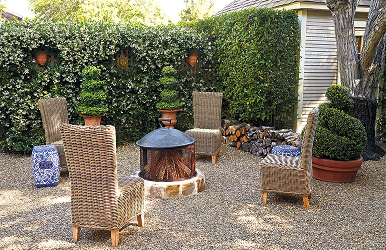 cozy-garden-firepit: Wicker lookalikes, these chairs are actually a manmade material over an aluminum frame so they can stay outdoors all year.