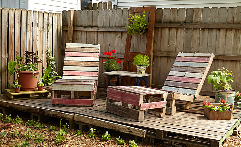 budget-friendly-pallet-furniture-lead: Pallet furniture painted to suit your garden’s color scheme is as ornamental as it is comfortable.
