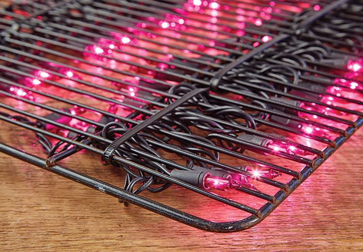 string lights for heat for seedlings: If you don't want to invest in a heat mat for plants, you can also use string lights attached to a baker's cooling rack to create bottom heat for starting seeds.