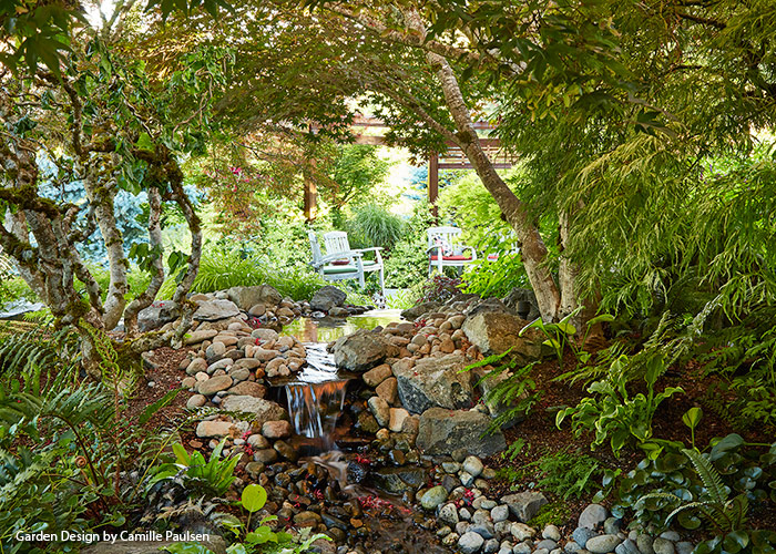 Paulsen water feature view from entry: The slope is smaller here and the stream narrower, so the water has a quiet, gentle flow that provides a peaceful mood for the entry garden.