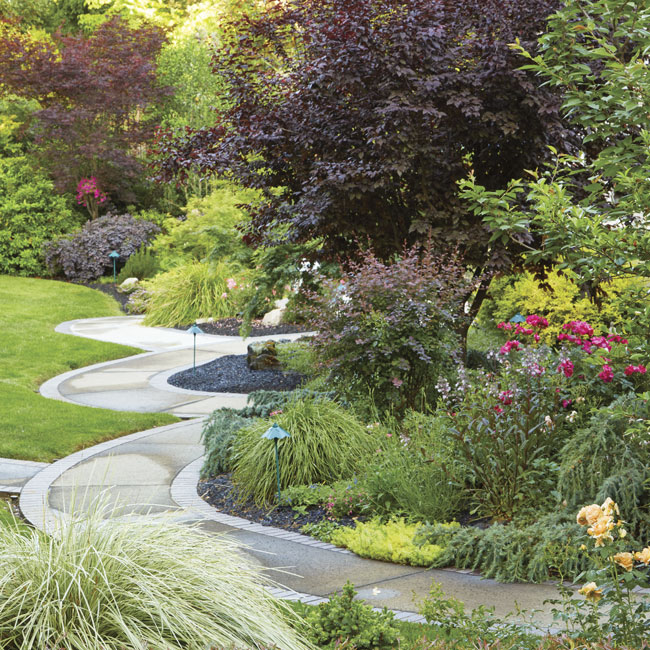 Ruby Andrews patio: Follow the sidewalk from the patio out into the yard to discover more stone- and plant-filled beds.