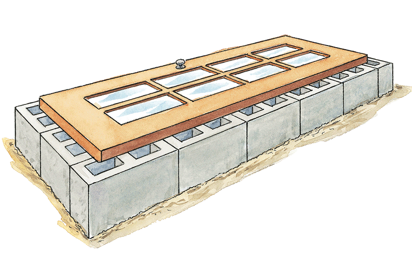 DIY-cold-frames-old-door: An old door on top of cinder blocks is an easy cold frame.