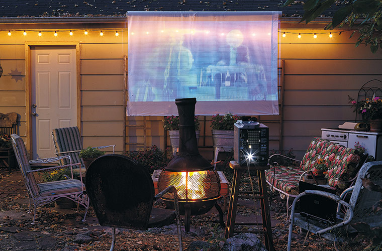 budget-friendly-outdoor-movie-night:Turn your backyard into a theater and save money by staying home and watching a DVD on a projector.