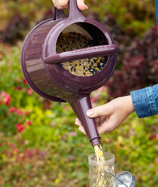 Use a watering can to refill bird feeders: Steady the spout as you pour to be extra sure the seed goes where it's supposed to. 