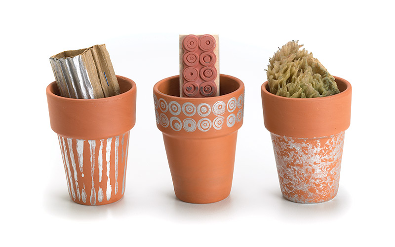 Create-a-childs-garden-personalize-terra-cotta-pots: Personalizing terra-cotta pots with your kids is a fun way to get them involved in the garden. 