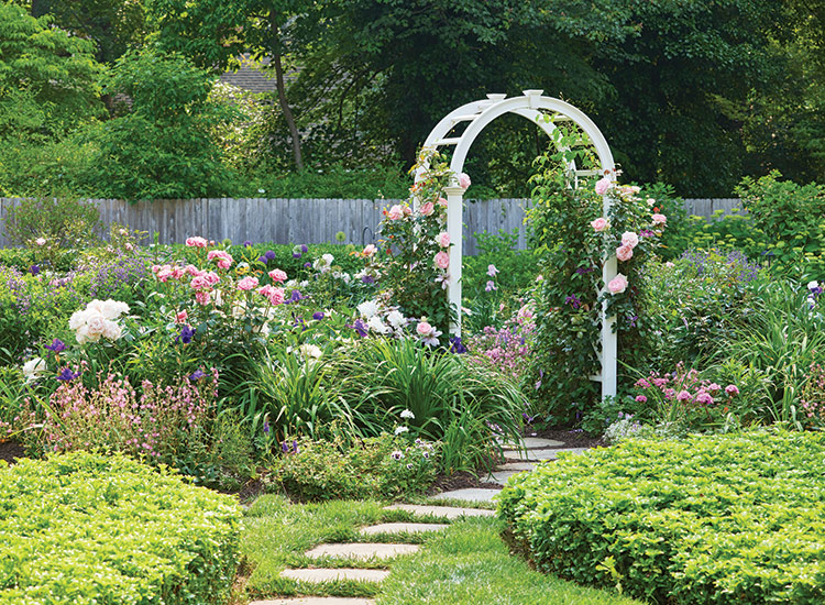Heather Thomas Cottage Garden white garden arbor and pathway: Climbing roses and clematis make a perfect pairing on the entry arbor: When the clematis has finished blooming, the roses takes center stage.