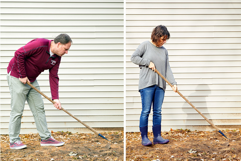 A short person and tall person holding same garden hoe to show posture difference: To hold the same hoe at the correct angle, you can see how a taller gardener, on the left, has to bend over more than a shorter person, on the right, who should grip the hoe further up the handle so it is not awkward to hold.