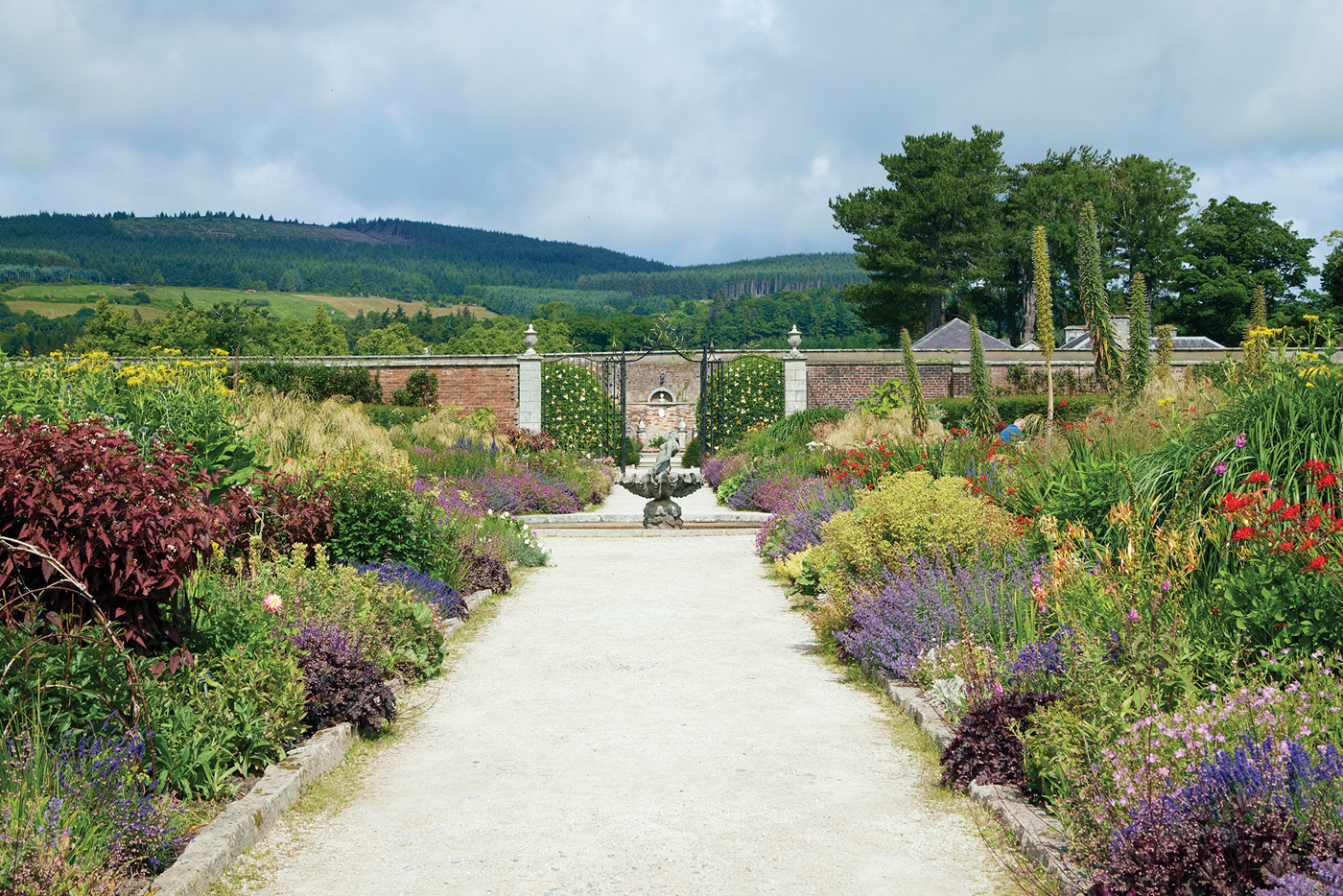Double borders at Powerscourt Estate in Ireland: When designing borders, it’s important to repeat key plants and colors to create rhythm and cohesion, and to draw the eye down the length of the planting.